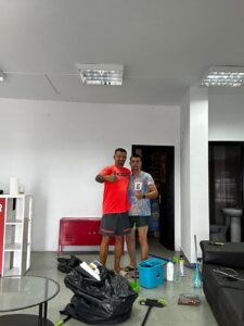 Modern rental office space with two men posing, cleaning tools, and supplies, emphasizing affordable and flexible rent options for commercial properties.