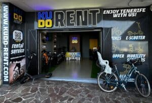 Electric scooter and bike rental shop in Tenerife, offering e-scooters, bikes, mobility scooters, and helmets for tourists exploring the island. Convenient rental service with a modern storefront.